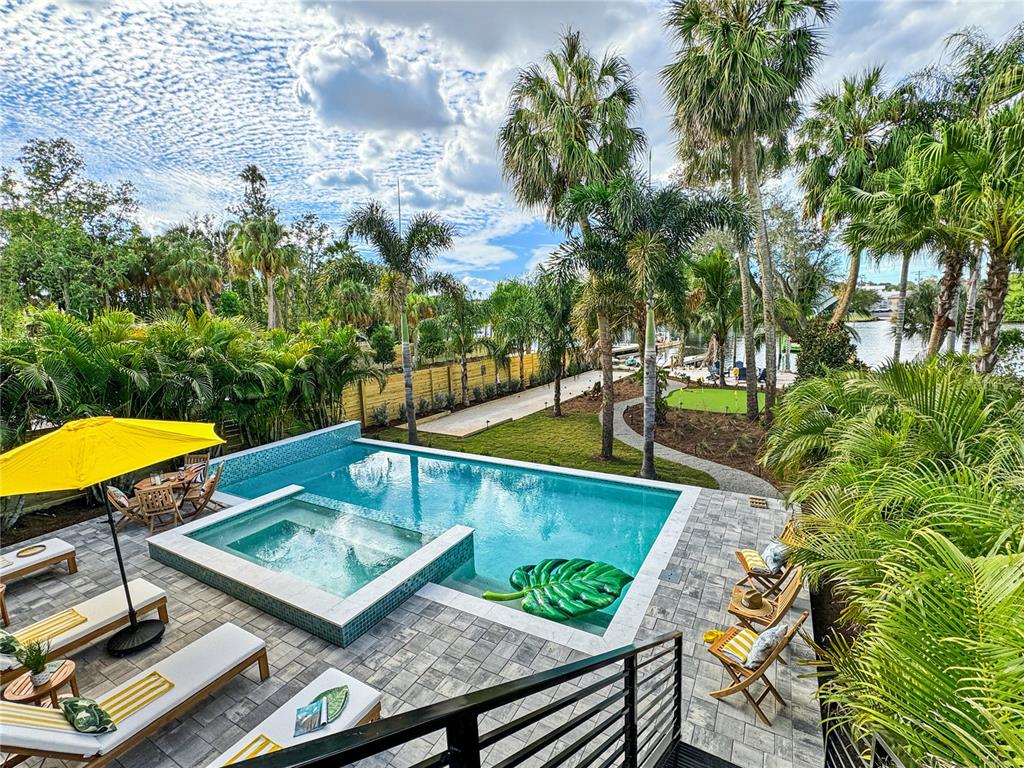An elevated view of a backyard featuring a swimming pool, hot tub, and palm trees — 2519 N RIVERSIDE DR, TAMPA, FL