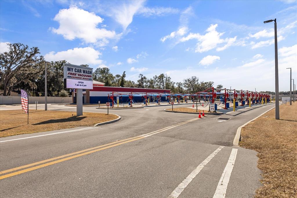 A car wash facility with a sign, vacuum stations, and a paved entrance driveway — 9820 SE US HIGHWAY 441, BELLEVIEW, FL