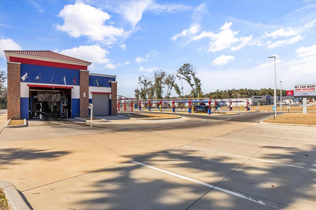 A car wash facility features a brick and blue exterior with a drive-through tunnel — 9820 SE US HIGHWAY 441, BELLEVIEW, FL