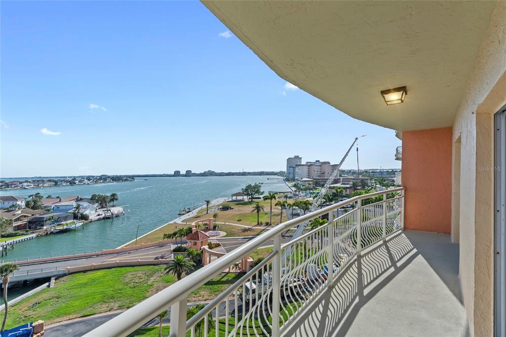 A high-angle view from a balcony overlooking a bay, a park, and nearby buildings — 4900 BRITTANY DRIVE S UNIT 808, ST PETERSBURG, FL