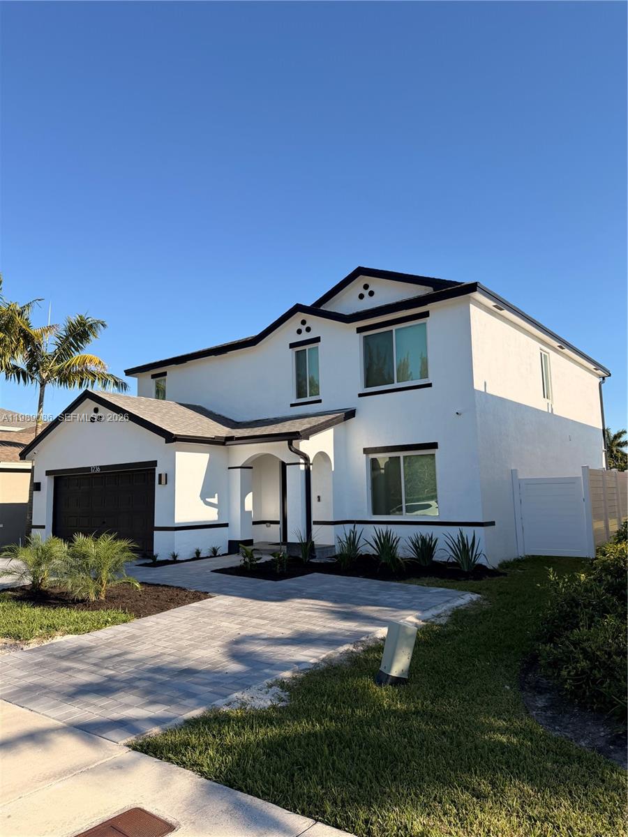 A two-story white house with a dark roof, garage, and paved driveway under a clear sky — 1236 NW 208th St, Miami Gardens FL 33169, MIAMI GARDENS, FL