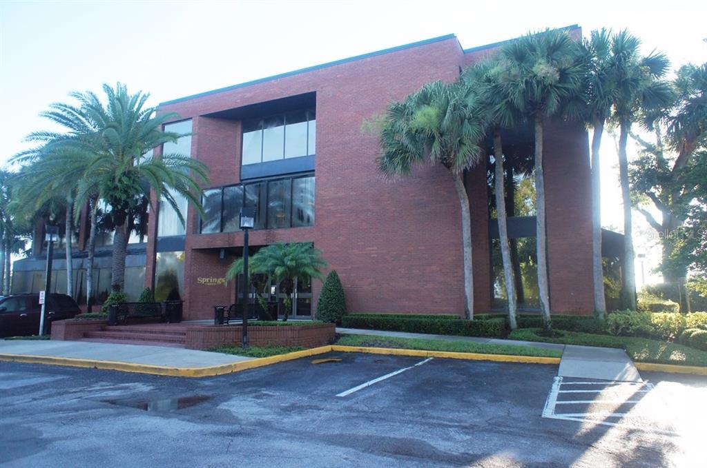 A three-story red brick office building features large windows and palm trees in the front — 2101 STATE RD 434, LONGWOOD, FL