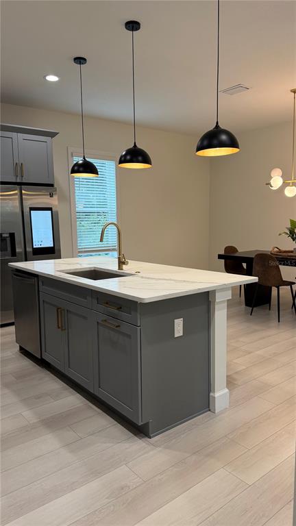 A bright, empty room features white walls, light wood-look flooring, and a modern ceiling fan — 4917 N NEBRASKA AVENUE, TAMPA, FL