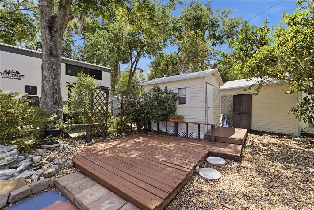 A wooden deck sits in front of a small shed and a parked recreational vehicle — 10173 N SUNCOAST BOULEVARD UNIT 80, CRYSTAL RIVER, FL