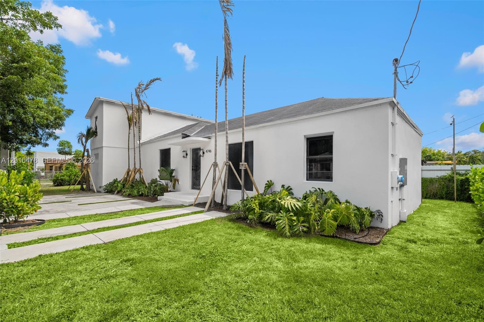 A white, single-story house with a flat roof and a small two-story section — 4746 NW 10th Ave, Miami FL 33127, MIAMI, FL