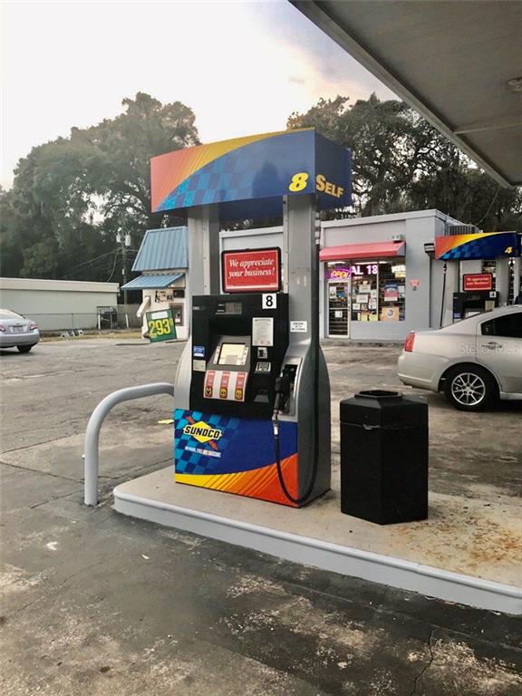 A Sunoco gas pump stands on a concrete island in front of a convenience store — 1800 S FRENCH AVENUE, SANFORD, FL