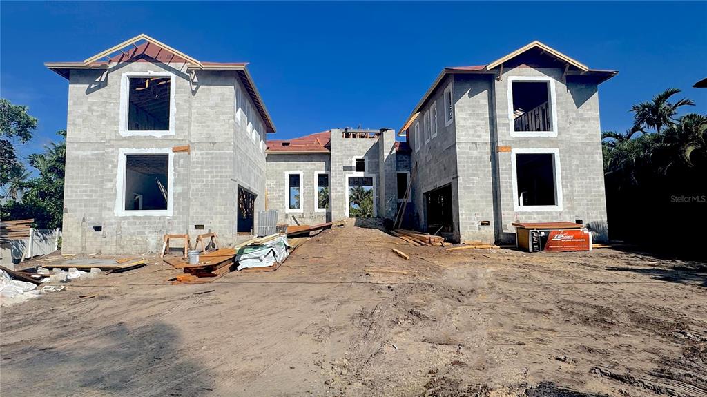 A two-story concrete block house under construction with an open entryway and roof framing — 3441 GULFMEAD DRIVE, SARASOTA, FL
