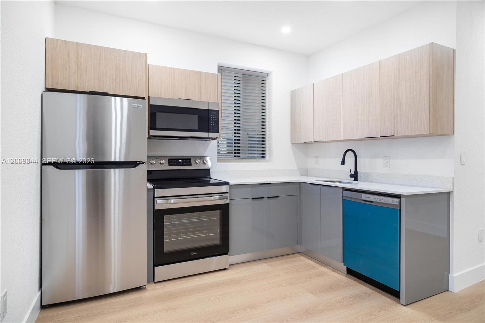 A kitchen features stainless steel appliances, light wood upper cabinets, and grey lower cabinets — 629 SW 10th Ave # 6, Miami FL 33130, MIAMI, FL