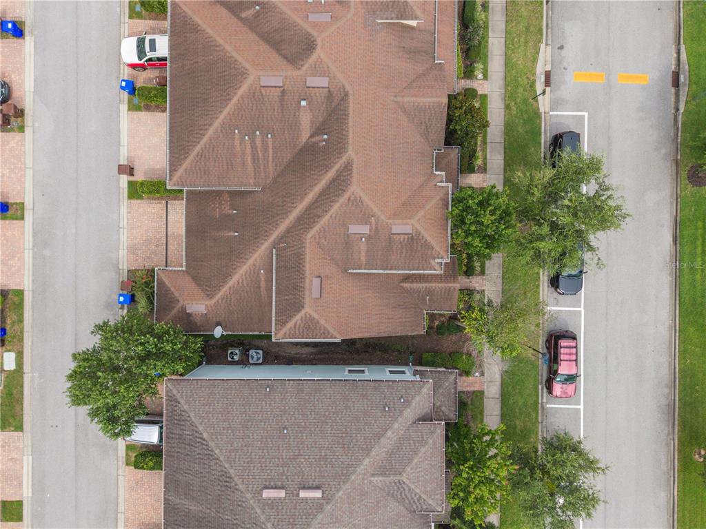 An exterior view of a two-story house with a brown shingle roof and garage — 2569 FOLIO WAY, KISSIMMEE, FL