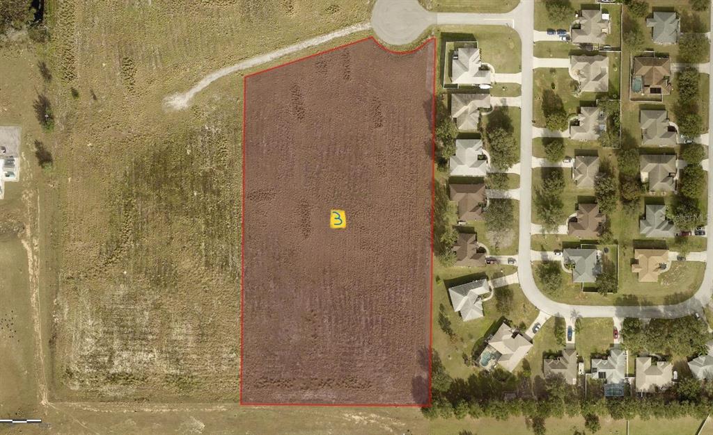 An aerial view shows a vacant rectangular lot outlined in red next to a residential neighborhood — LOT 3 MERCADO COURT, CLERMONT, FL