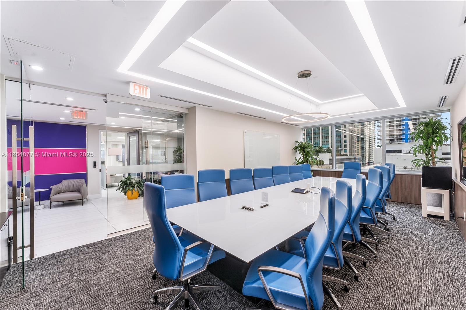 A modern conference room features a long white table, blue chairs, and floor-to-ceiling windows — 1200 Brickell Ave # A, Miami FL 33131, MIAMI, FL