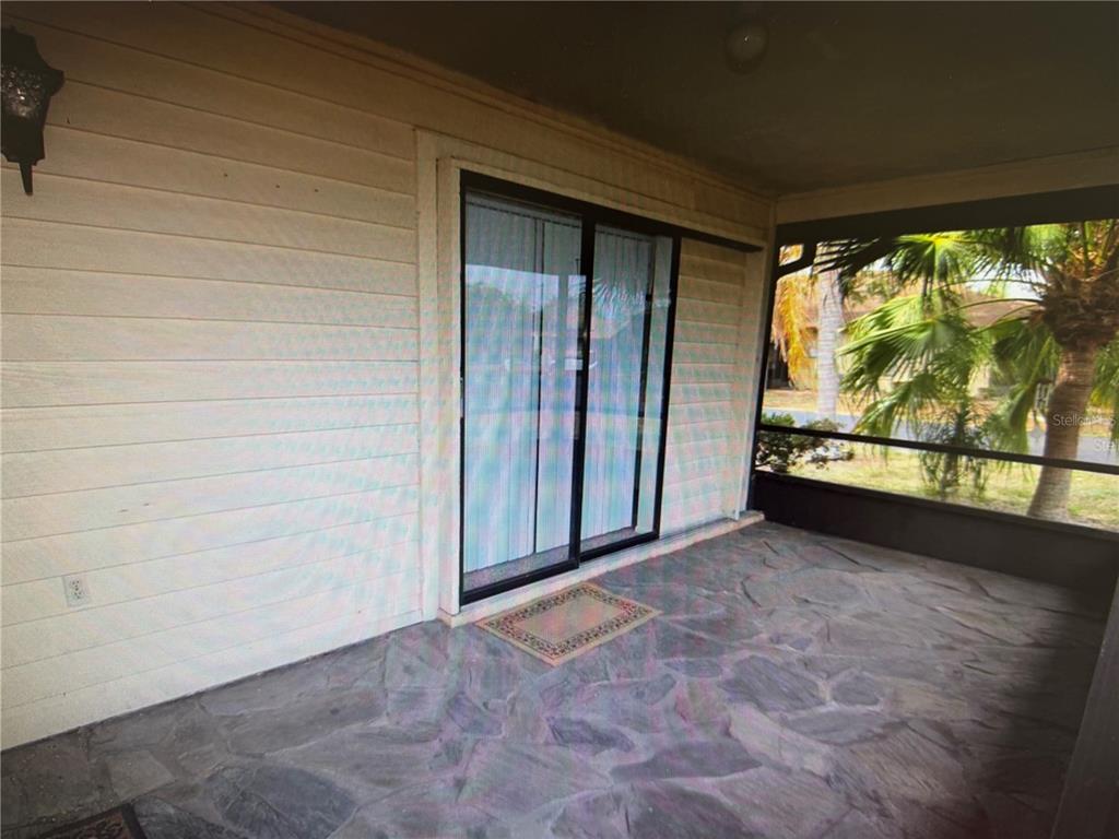 A single-story residential building with a parking lot in the foreground — 4161 66TH STREET CIRCLE W, BRADENTON, FL