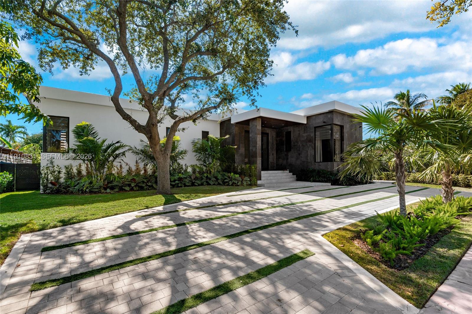 A modern single-story house features a stone facade, flat roof, and a paved driveway — 270 N Shore Dr, Miami Beach FL 33141, MIAMI BEACH, FL