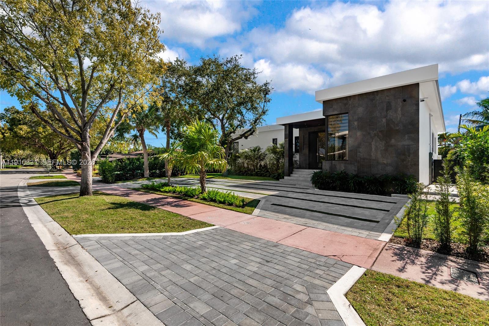 A modern house with a dark stone facade and a paved driveway sits on a street — 270 N Shore Dr, Miami Beach FL 33141, MIAMI BEACH, FL