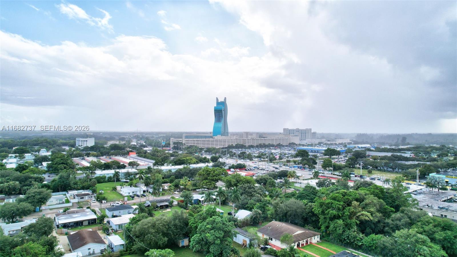 An aerial view shows a residential neighborhood with a prominent guitar-shaped hotel in the distance — 4381 SW 51st St, Dania Beach FL 33314, DANIA BEACH, FL