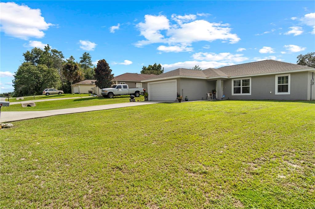 A single-story house with a two-car garage and a large front lawn — 14626 SW 79TH TERRACE ROAD, OCALA, FL