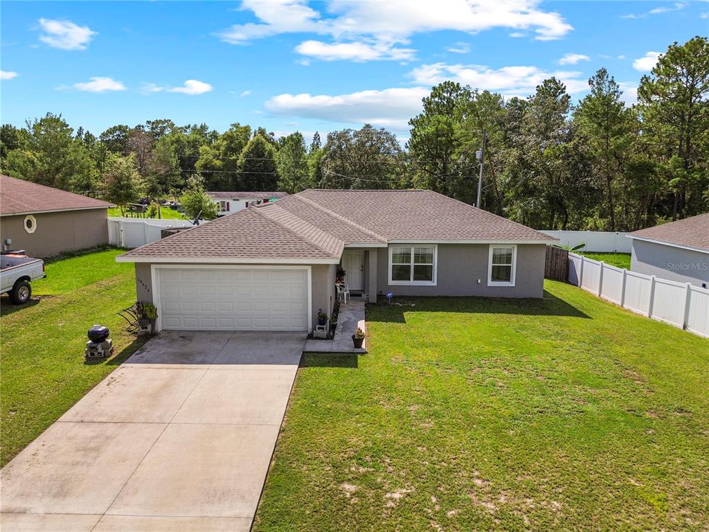 An aerial view shows the shingled hip roof of a house surrounded by a grassy yard — 14626 SW 79TH TERRACE ROAD, OCALA, FL