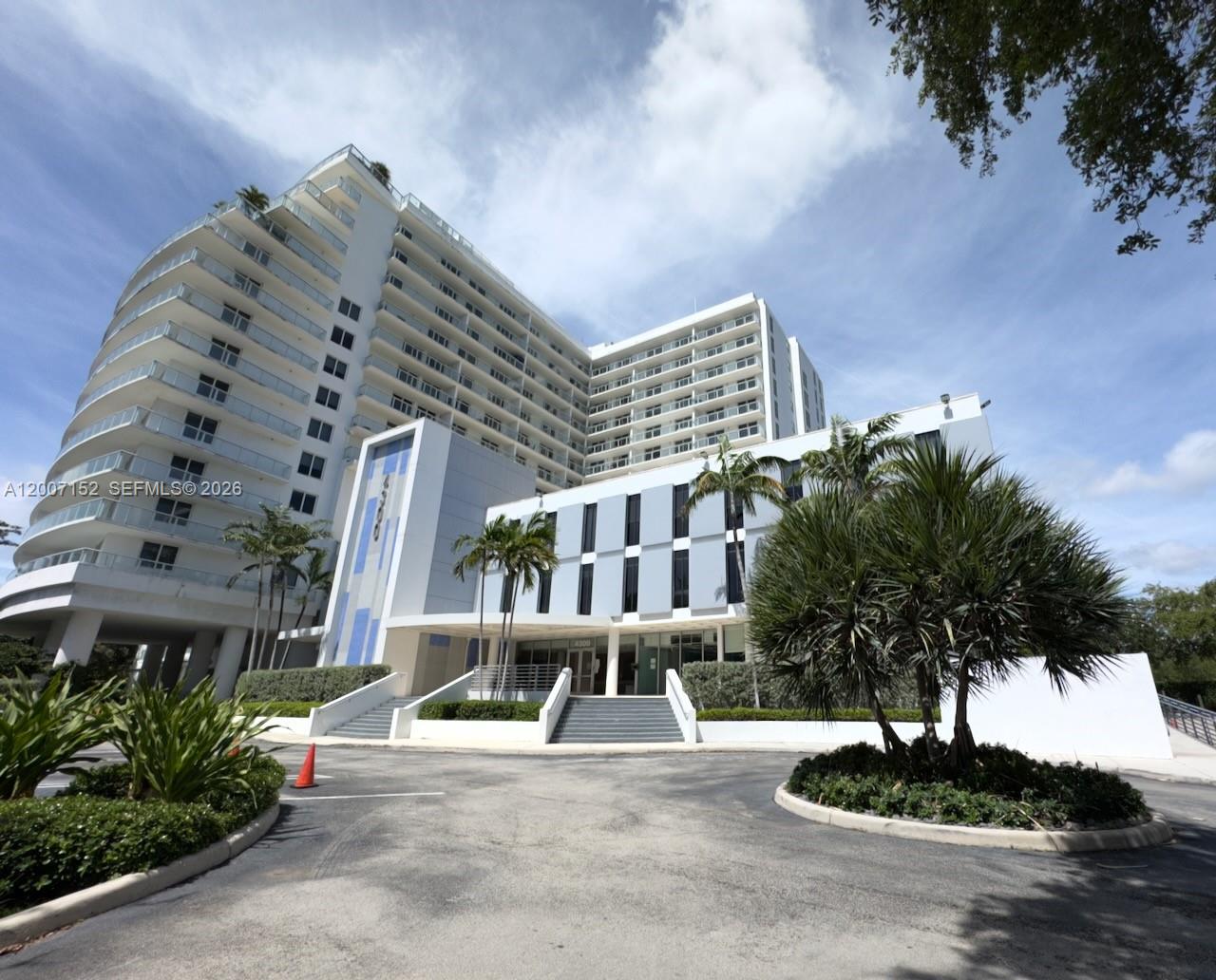 A multi-story residential building with curved balconies and a paved entrance driveway — 4300 Biscayne Blvd # 206, Miami FL 33137, MIAMI, FL