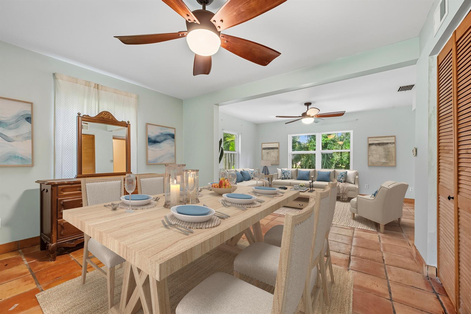 A dining area with a wooden table and chairs opens into a living room — 1398 SW Palm City Road, Stuart FL 34994, STUART, FL