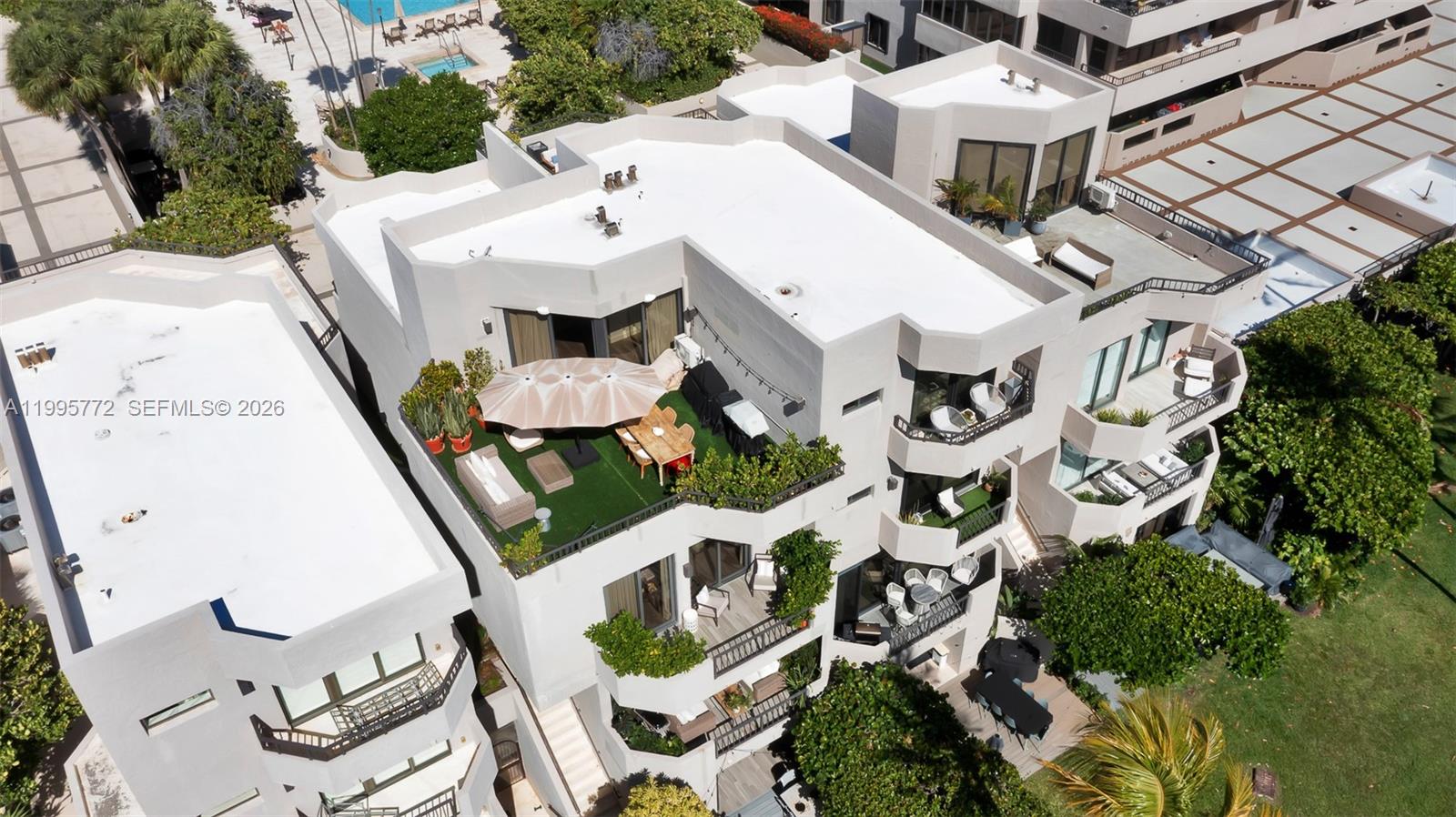 An aerial view shows a multi-story building with a large rooftop terrace and balconies — 201 Crandon Blvd # 175, Key Biscayne FL 33149, KEY BISCAYNE, FL