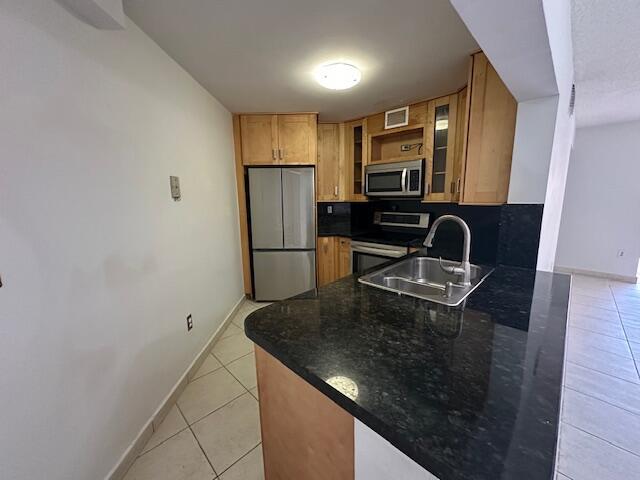 A kitchen features light wood cabinets, stainless steel appliances, and dark granite countertops — 10237 NW 9th St Circle # 4, Miami FL 33172, MIAMI, FL