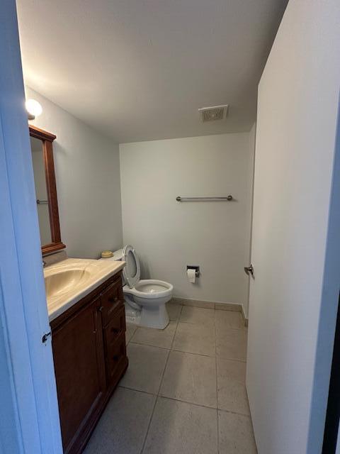 A bathroom features a wooden vanity with a sink, a toilet, and light-colored tile flooring — 10237 NW 9th St Circle # 4, Miami FL 33172, MIAMI, FL