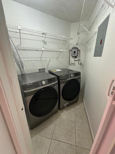 A laundry closet with two gray Samsung appliances, wire shelving, and a wall-mounted water heater — 10237 NW 9th St Circle # 4, Miami FL 33172, MIAMI, FL