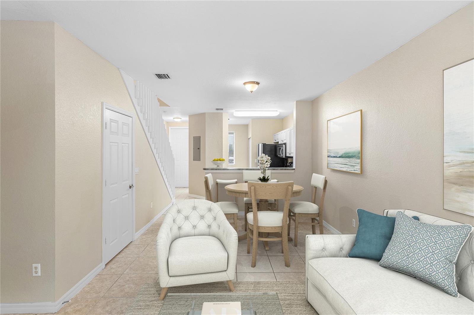 A living room and dining area with tile floors, a staircase, and an open kitchen — 1992 Alamanda Way # 1992, Riviera Beach FL 33404, RIVIERA BEACH, FL