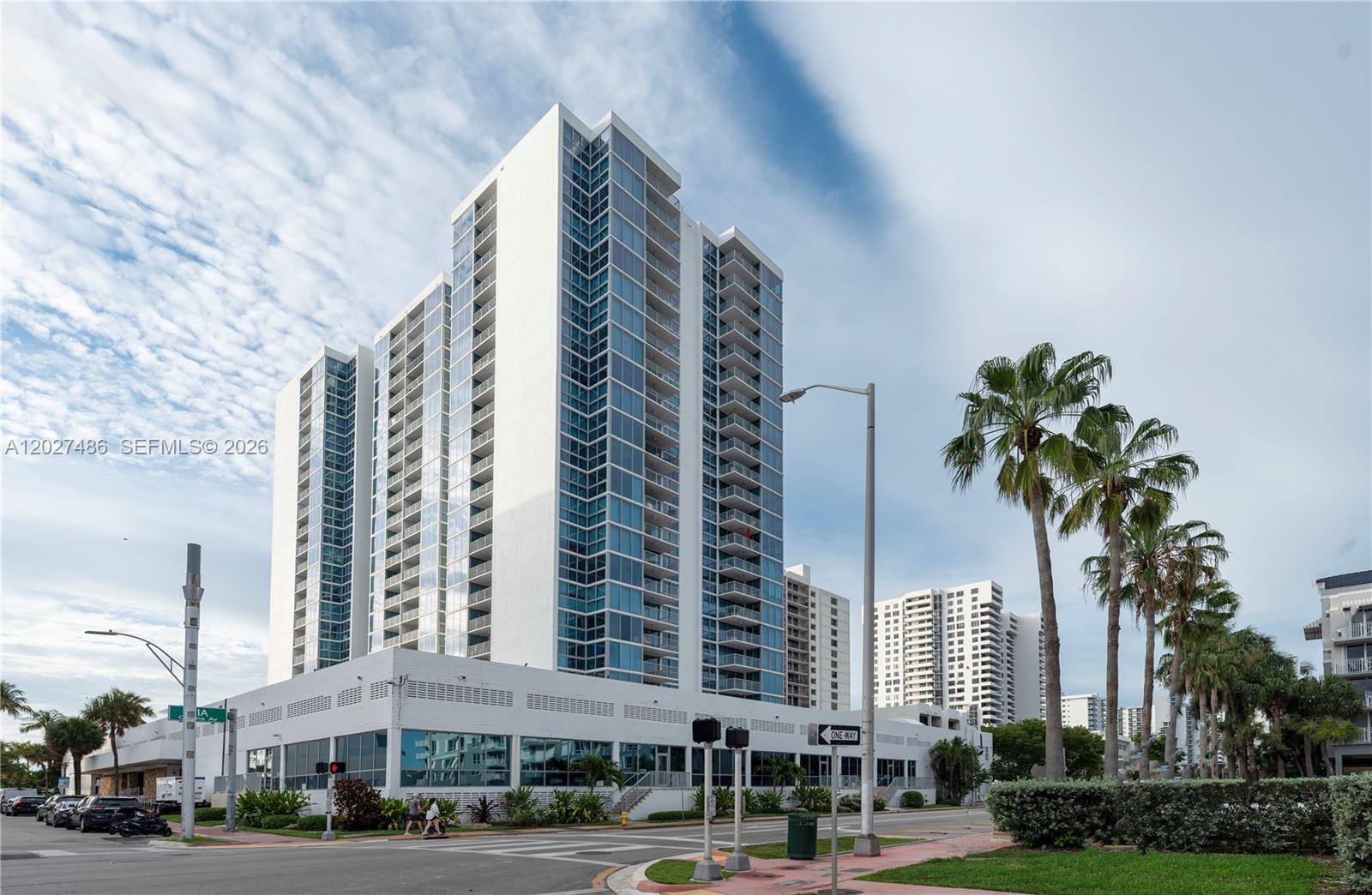 A tall white residential high-rise building stands near a street with palm trees — 2655 Collins Ave # 603, Miami Beach FL 33140, MIAMI BEACH, FL