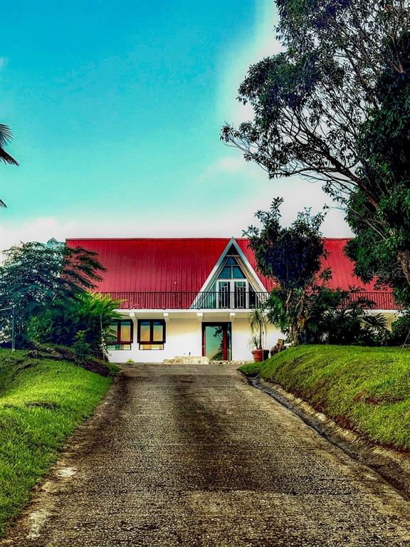 A two-story house with a red metal roof and a central A-frame balcony — PR 152 PR 773, BARRANQUITAS, PR