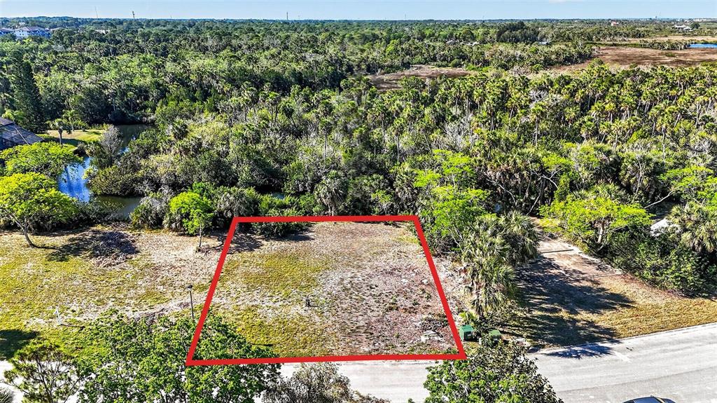 An aerial view shows a rectangular vacant lot outlined in red next to a road — 5804 SEABREEZE DRIVE, PORT RICHEY, FL