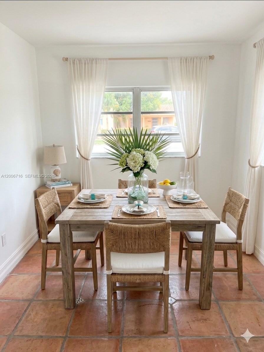 A dining room features a wooden table with four woven chairs on terracotta tile flooring — 3831 E 10th Ave, Hialeah FL 33013, HIALEAH, FL