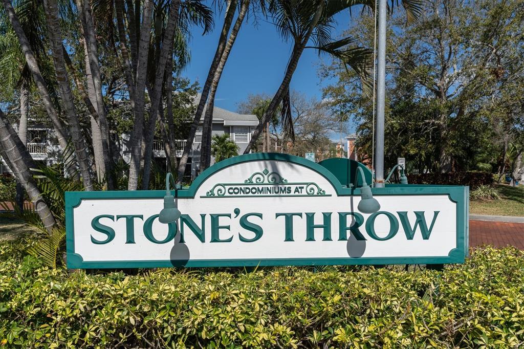 A sign for the Stone's Throw condominiums stands in front of trees and buildings — 6931 STONES THROW CIRCLE N UNIT 5302, ST PETERSBURG, FL