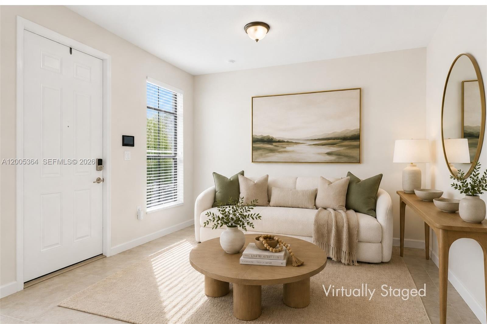 This virtually staged living room features a white sofa, round coffee table, and console table — 11738 SW 238th St, Homestead FL 33032, HOMESTEAD, FL