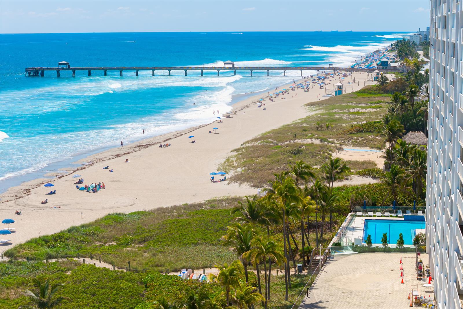 An aerial view of a sandy beach, a long pier, and a swimming pool deck — 3000 S Ocean Boulevard # 1404, Boca Raton FL 33432, BOCA RATON, FL