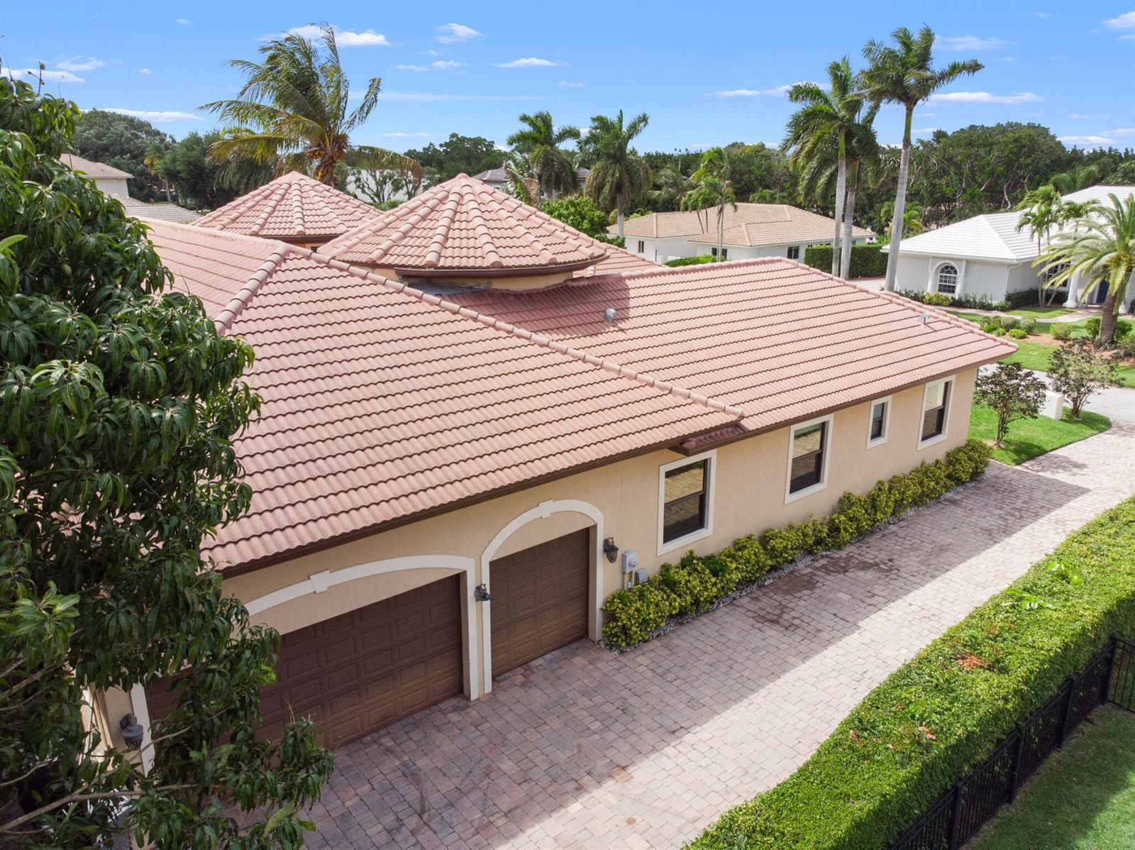 An aerial view of a tan house with a tiled roof and a two-car garage — 4190 Gleneagles Drive, Boynton Beach FL 33436, BOYNTON BEACH, FL