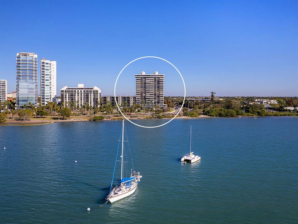A room with floor-to-ceiling windows overlooking a bay, featuring built-in white shelving and cabinetry — 770 S PALM AVENUE UNIT 1201, SARASOTA, FL
