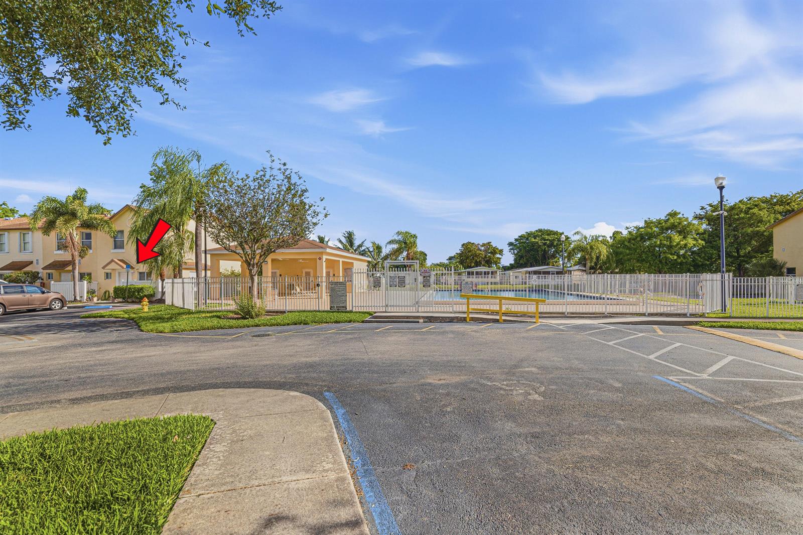 A view of a parking lot, a swimming pool area, and a multi-story residential building — 6631 Winfield Boulevard # 6, Margate FL 33063, MARGATE, FL