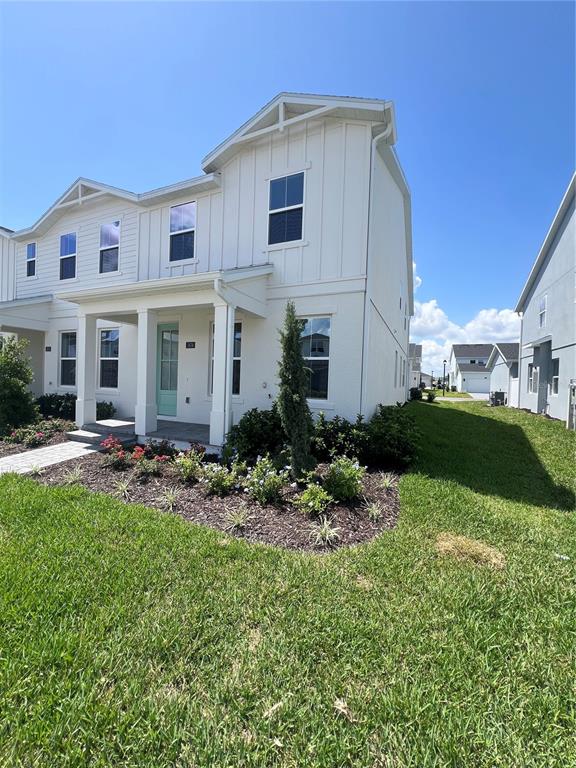 A two-story white house with vertical siding and a light blue front door — 1876 CROWNCREST DRIVE, APOPKA, FL