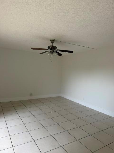 An empty room features white walls, a tiled floor, and a ceiling fan — 3001 San Clara Drive # a, Delray Beach FL 33445, DELRAY BEACH, FL