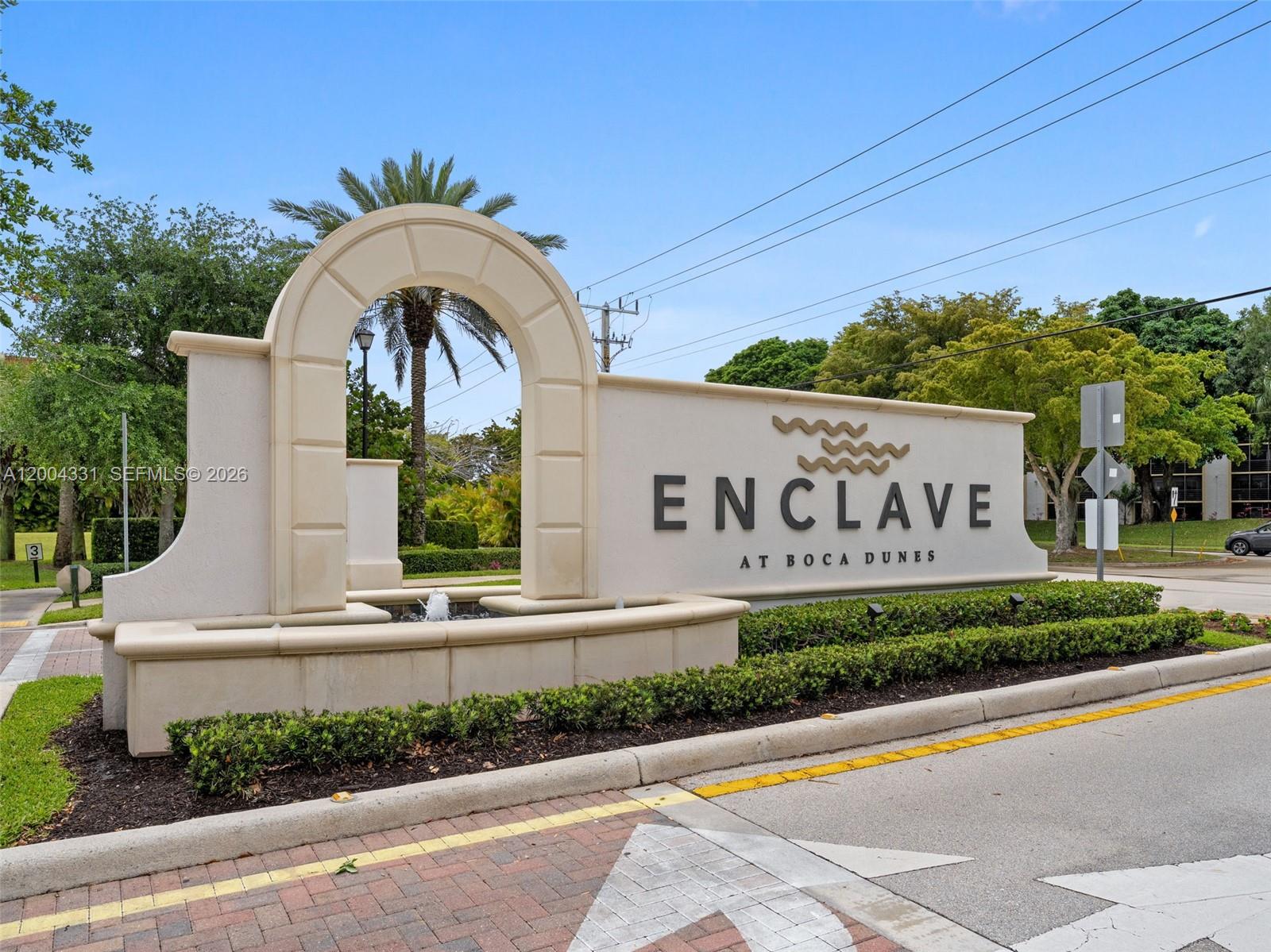 A stone monument sign for Enclave at Boca Dunes features an arched fountain and landscaping — 10105 Brickhill Dr, Boca Raton FL 33428, BOCA RATON, FL