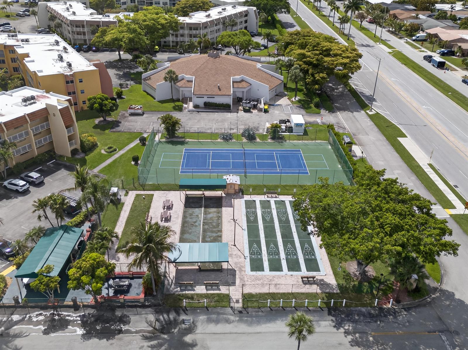 An aerial view shows a tennis court, shuffleboard courts, and a community building with parking — 6570 Royal Palm Boulevard # 306j, Margate FL 33063, MARGATE, FL