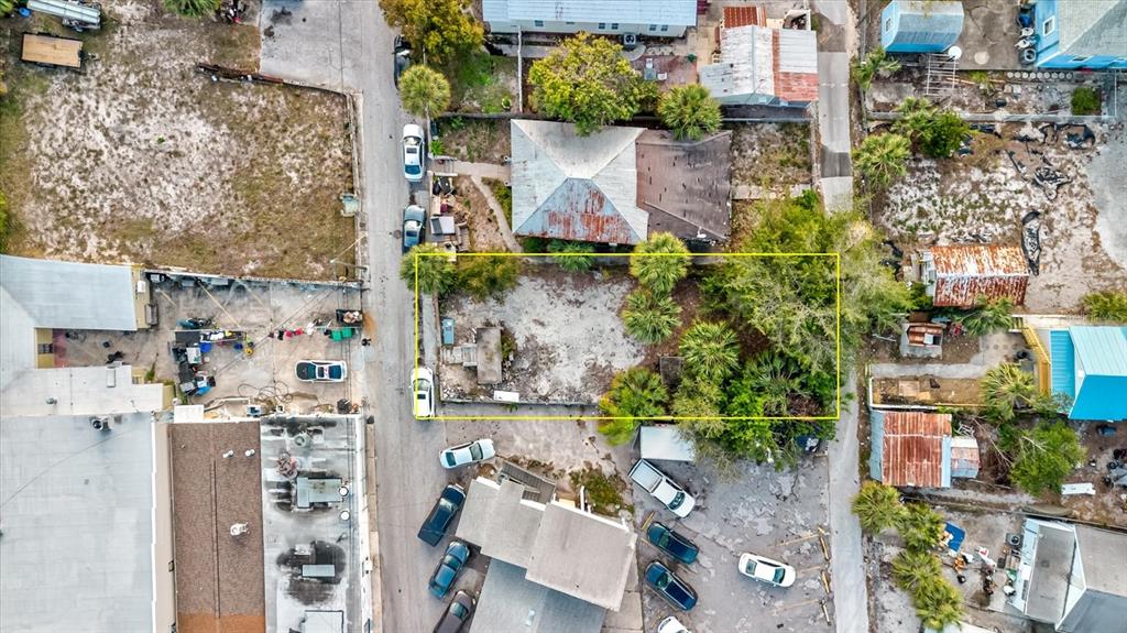 An aerial view shows a rectangular vacant lot surrounded by residential and commercial buildings — ATHENS STREET, TARPON SPRINGS, FL