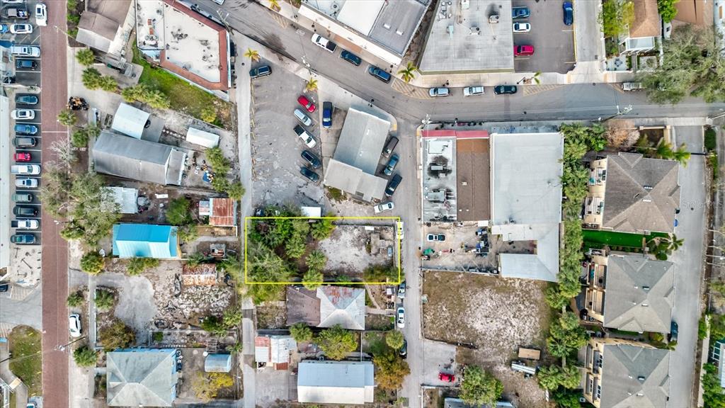 This aerial view shows a vacant, rectangular lot outlined in yellow within a city block — ATHENS STREET, TARPON SPRINGS, FL