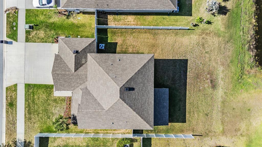 An aerial view shows a residential house with a shingled roof and a fenced yard — 13418 LAKEVIEW OAKS LANE, RIVERVIEW, FL