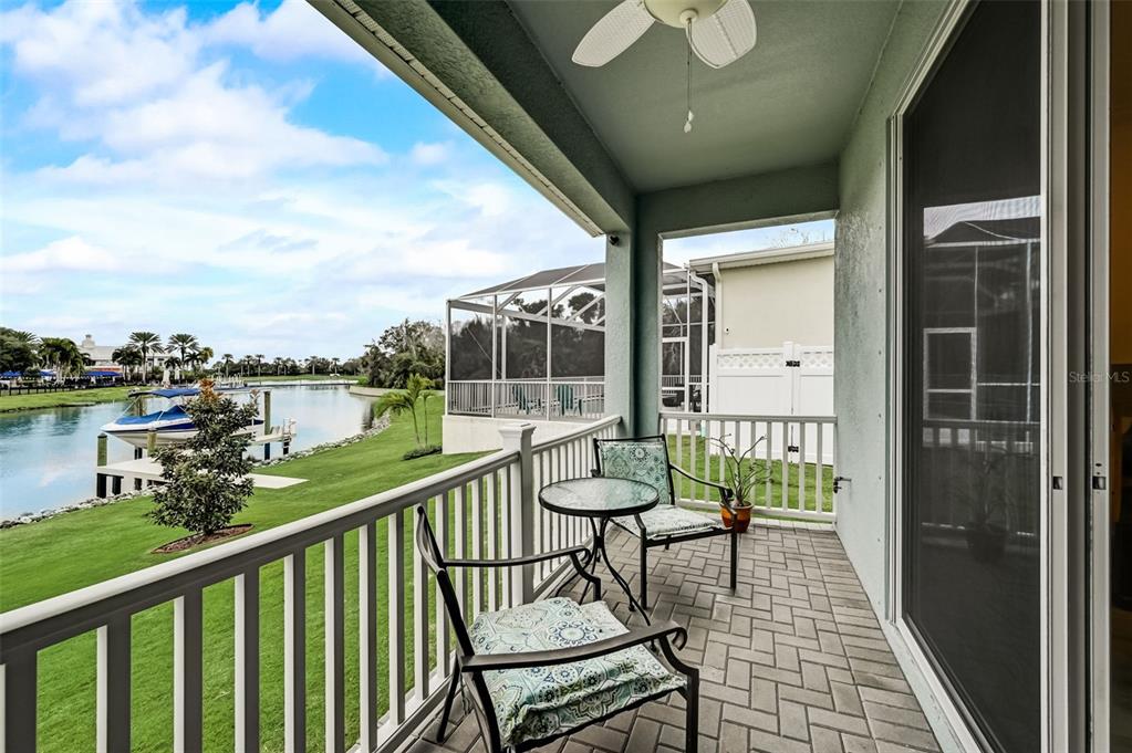 A covered balcony with a ceiling fan, patio furniture, and a view of a canal — 5413 WISHING ARCH DRIVE, APOLLO BEACH, FL