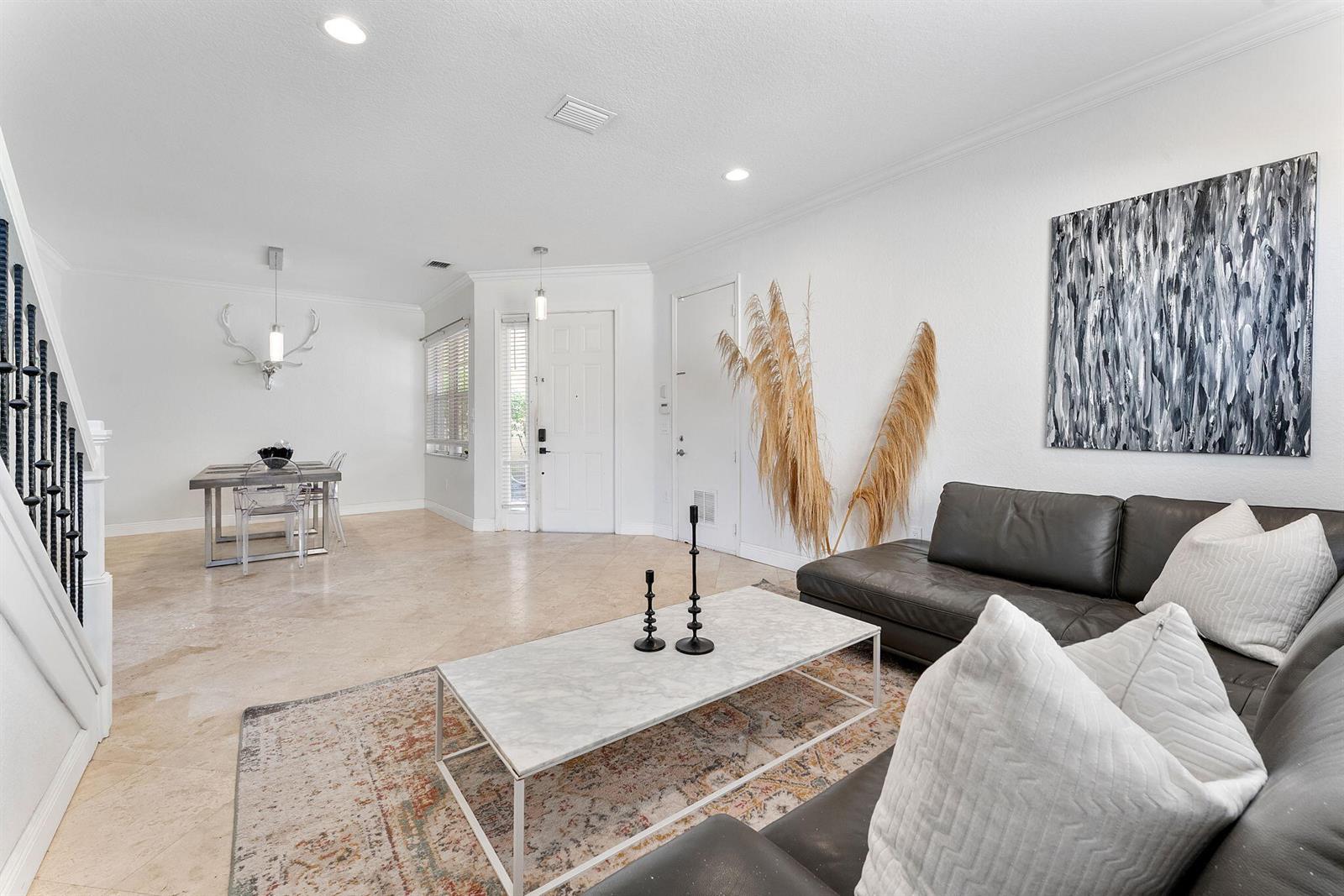 A living room and dining area with tile floors, a leather sofa, and modern decor — 7942 Parsons Pine Drive, Boynton Beach FL 33437, BOYNTON BEACH, FL