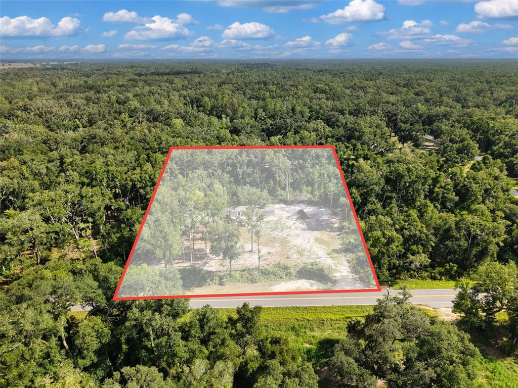 An aerial view shows a rectangular plot of land with a house surrounded by trees — 311 NE 316TH AVENUE, OLD TOWN, FL