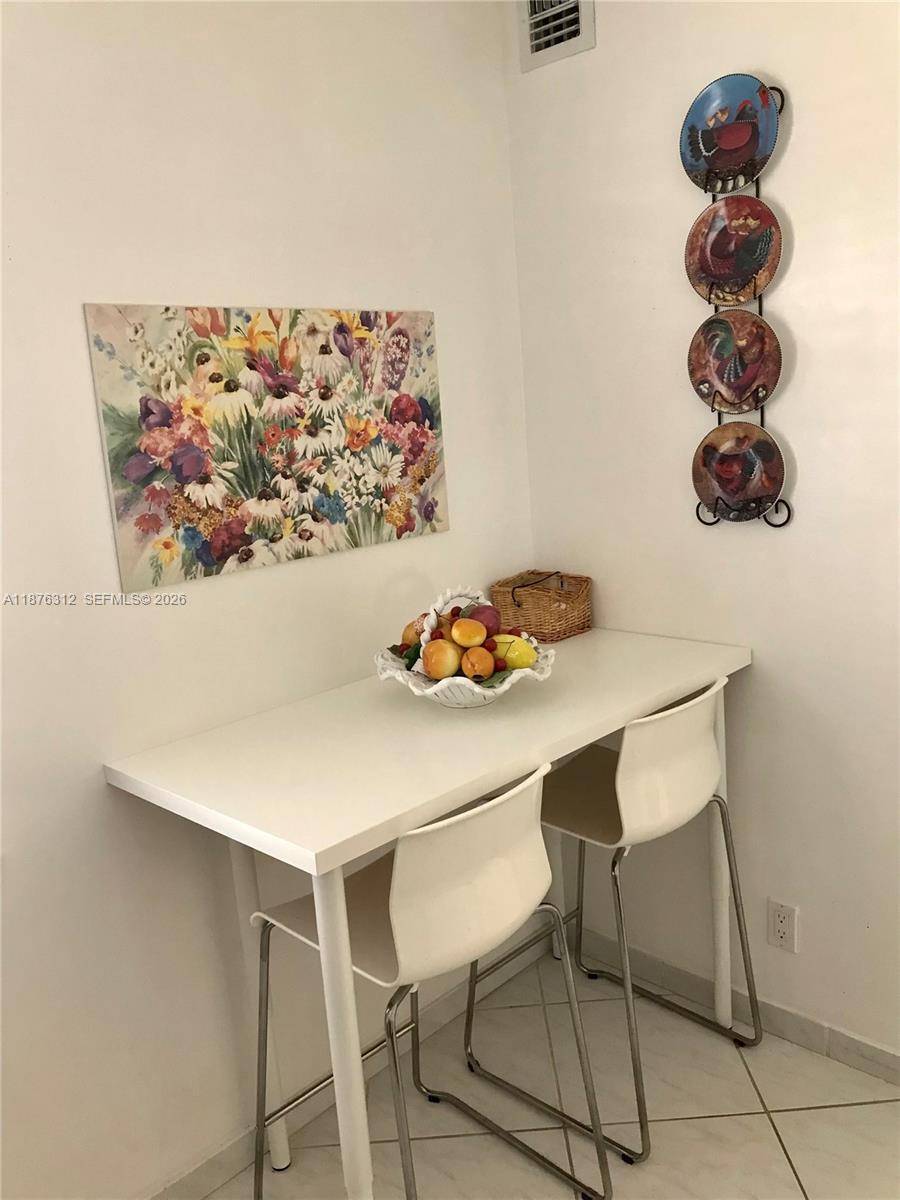 A white exterior door with a glass panel and integrated blinds sits in a textured wall — 1025 SE 4th Ave # 101, Dania Beach FL 33004, DANIA BEACH, FL