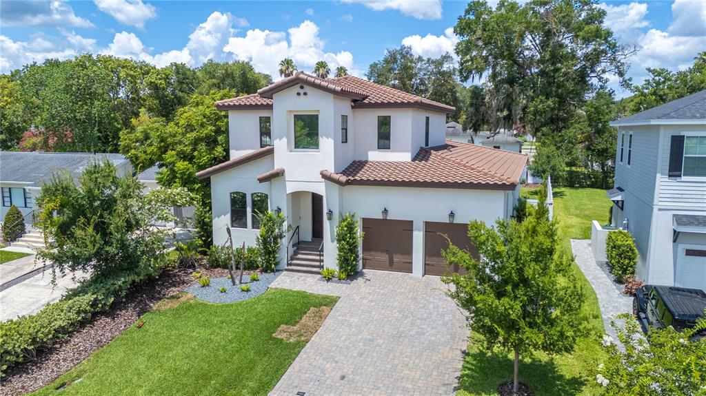 An aerial view of a two-story stucco house with a tile roof and two-car garage — 2403 DERBYSHIRE AVENUE, LAKELAND, FL